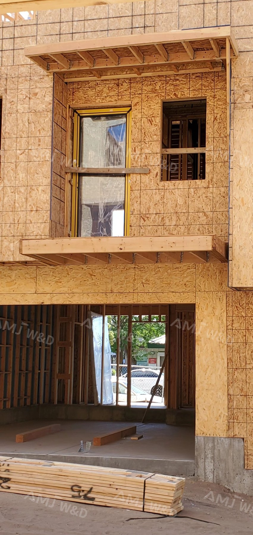 AMJ custom aluminum sliding door installation on wood frame construction