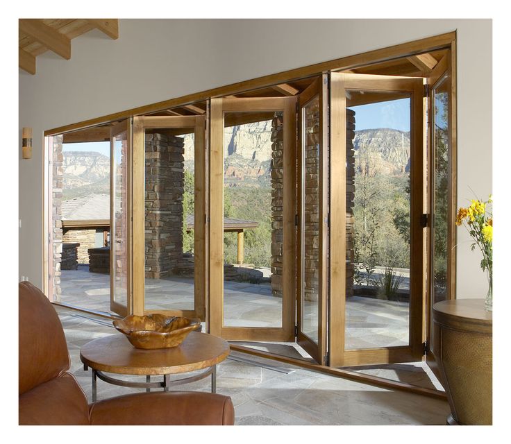 Aluminum bi fold doors opening a living space to an outdoor patio