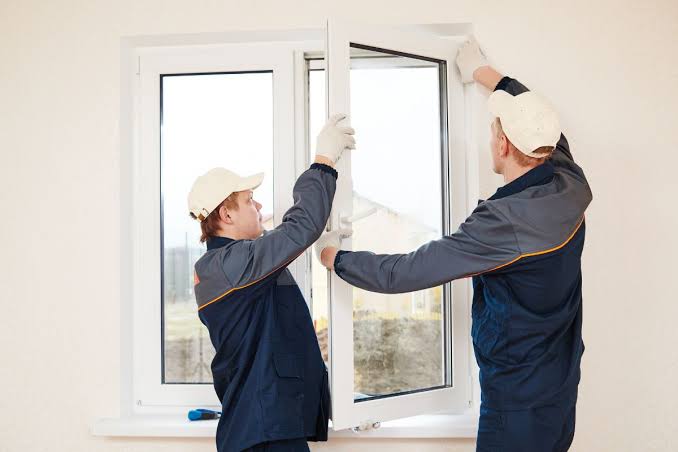 Aluminum casement window frame being installed in a prepared wall opening