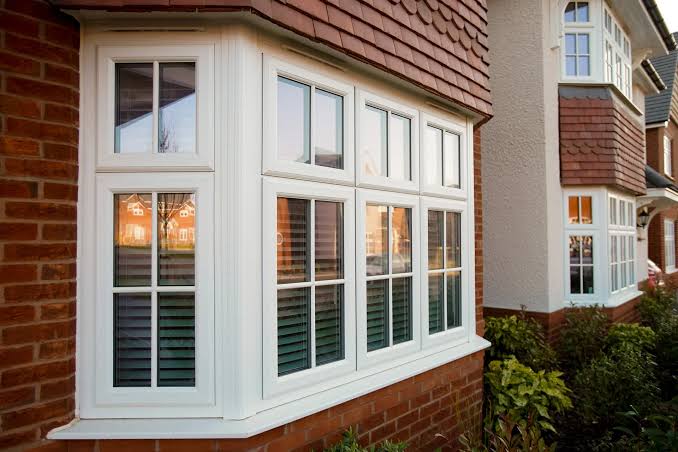 Three-panel bay window projecting beyond the exterior wall with a large center window and angled side windows.