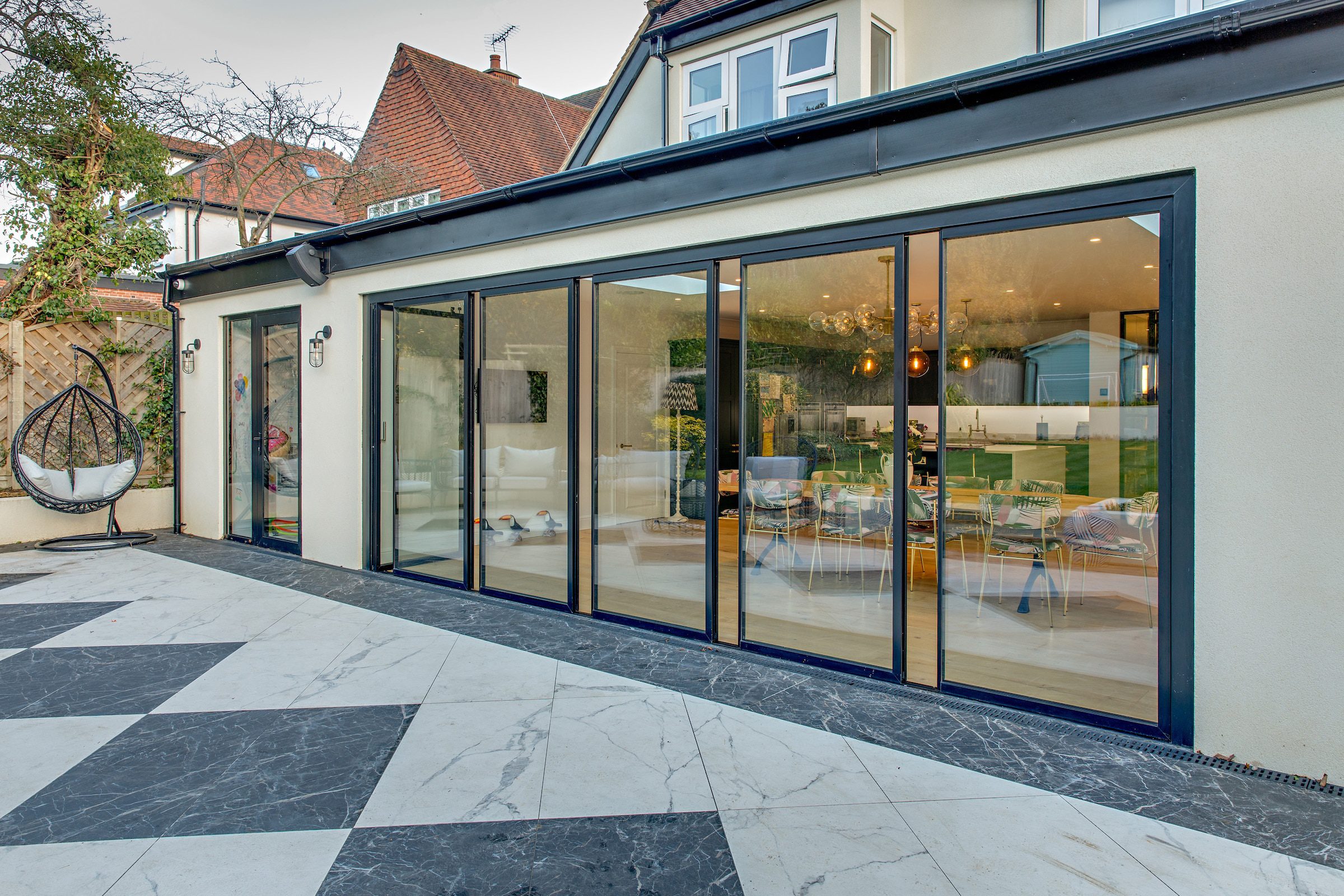  Slim aluminum sliding glass doors used as an alternative to bi-fold doors for a wide patio opening.